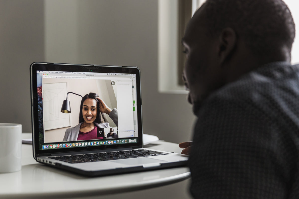 Man and woman on a video call discussing vendors
